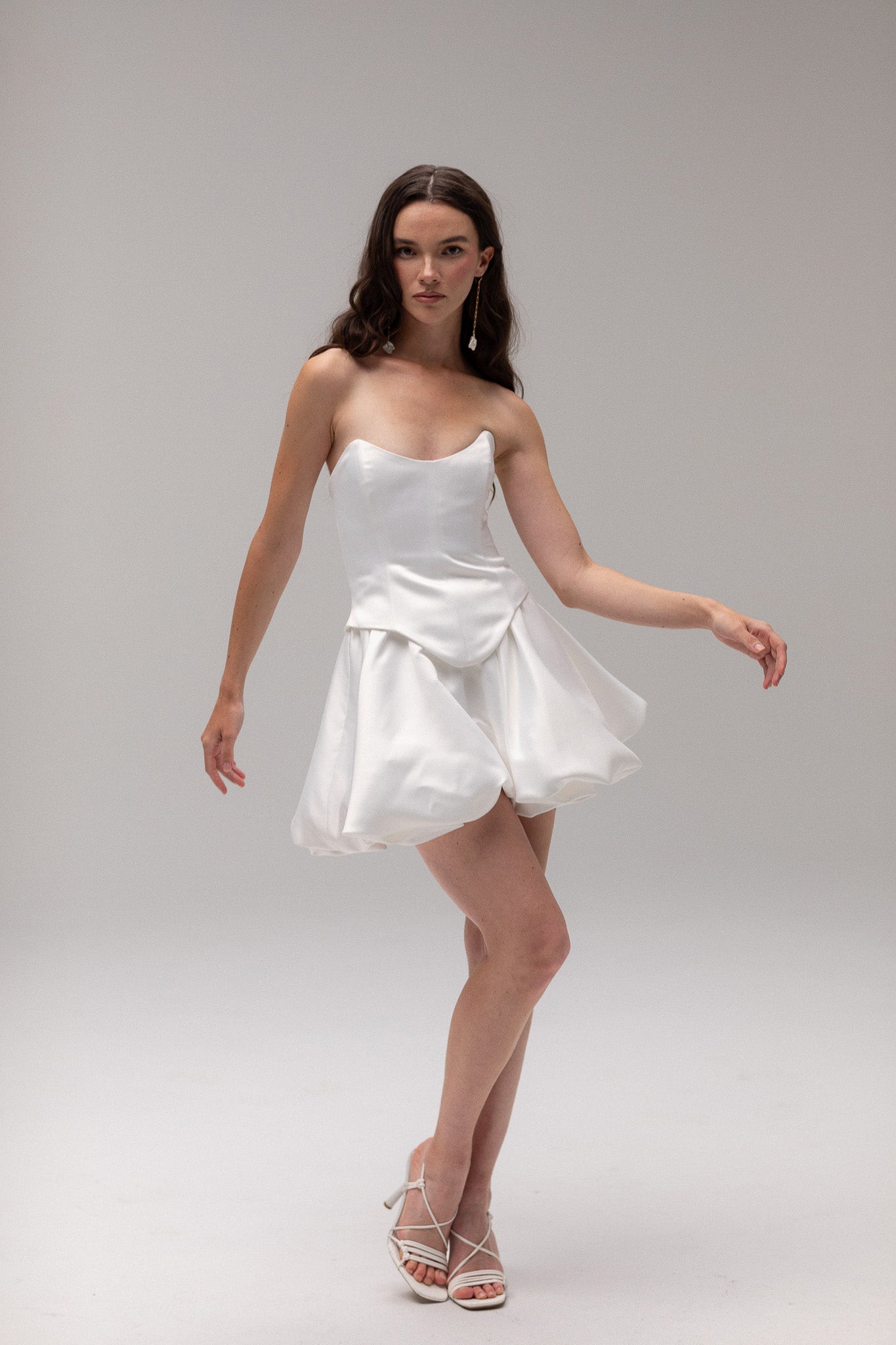 Detailed view of a satin mini bubble skirt, highlighting its playful silhouette and luxurious fabric, perfect for an unconventional bridal style