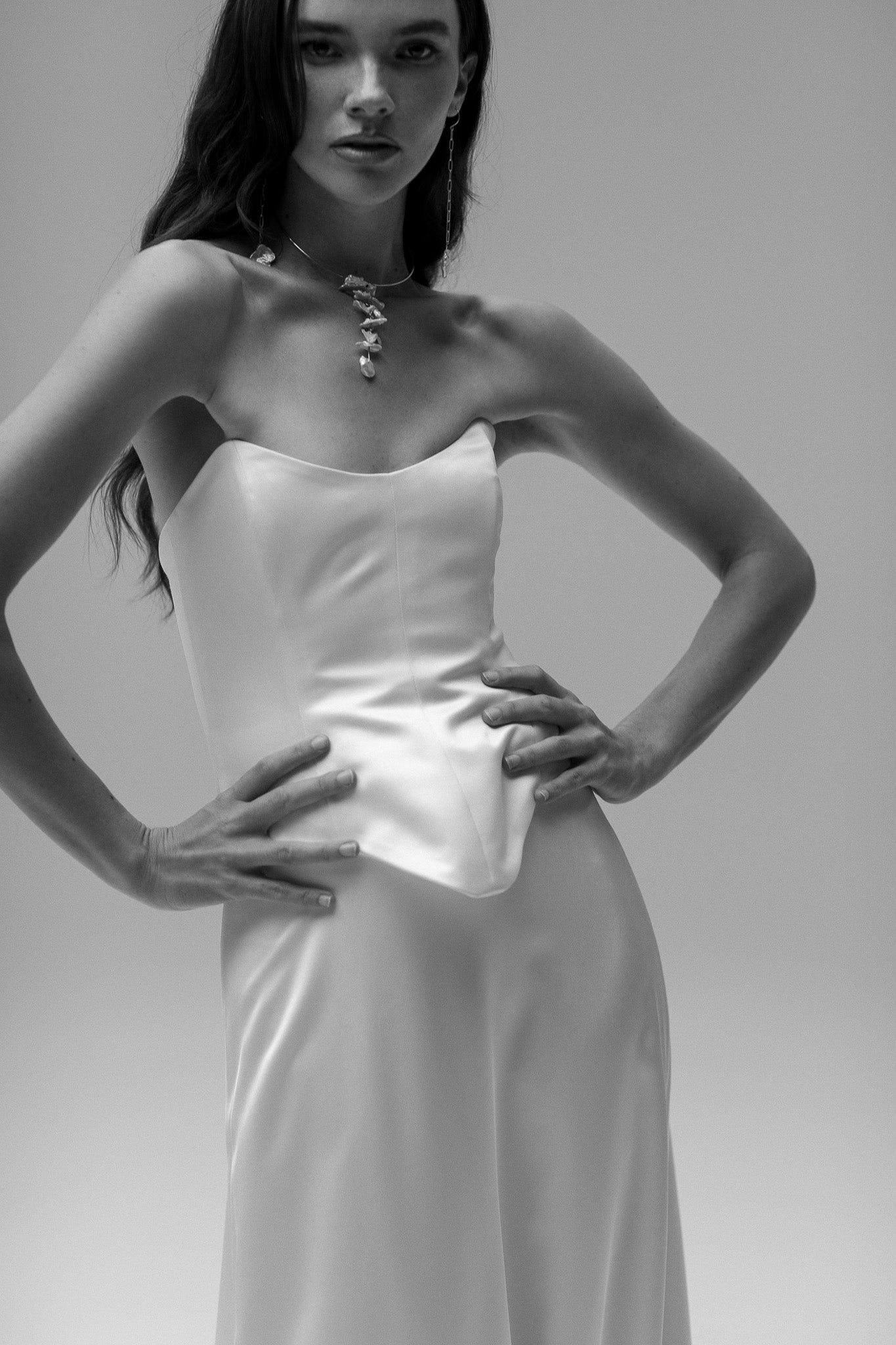 Model is wearing a satin corset top from TEMPÊTE, showcasing a sleek and tailored fit for a bold bridal outfit.