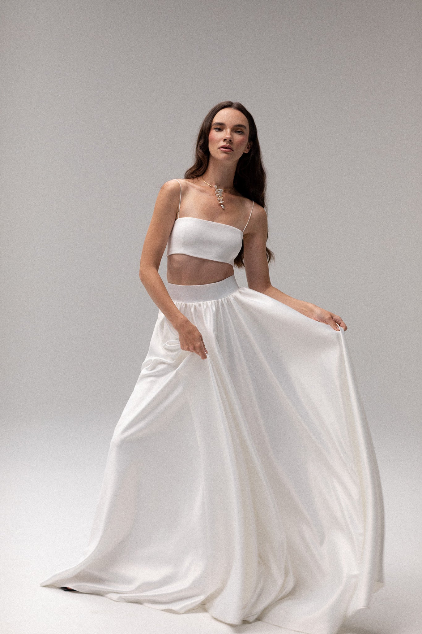 Detailed view of a high-waisted satin gathered maxi skirt by TEMPÊTE, offering an elegant and modern fit, perfect for creating a stunning wedding day outfit