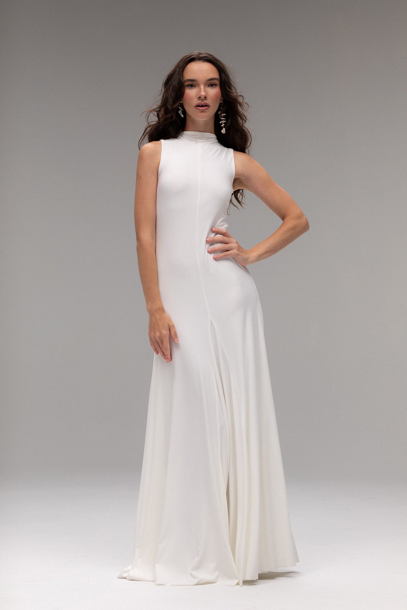 Bride in TEMPÊTE’s high neck knit dress, showcasing a form-fitting design with a voluminous bottom.