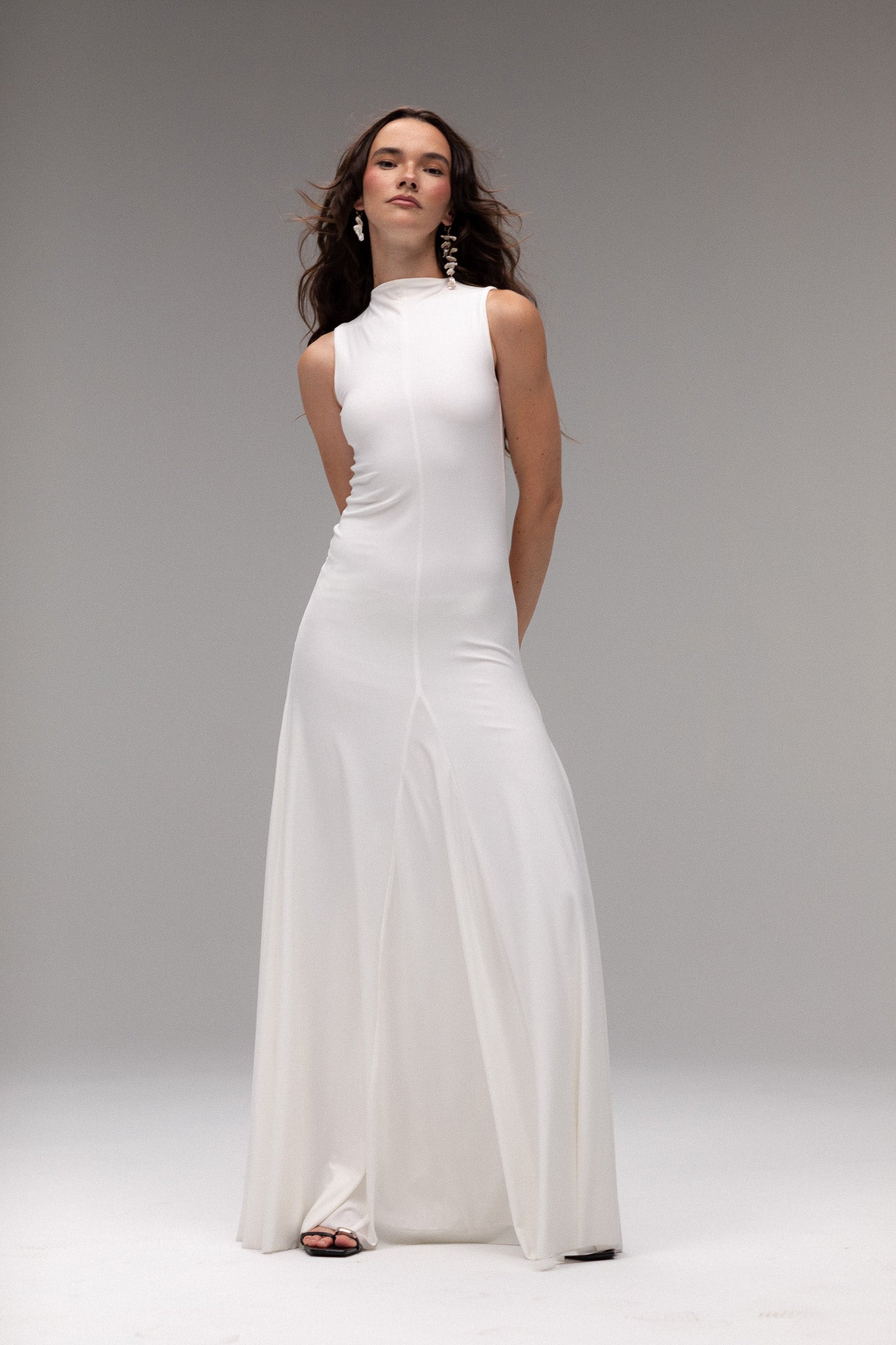 Bride in TEMPÊTE’s high neck knit dress, showcasing a form-fitting design with a voluminous bottom.