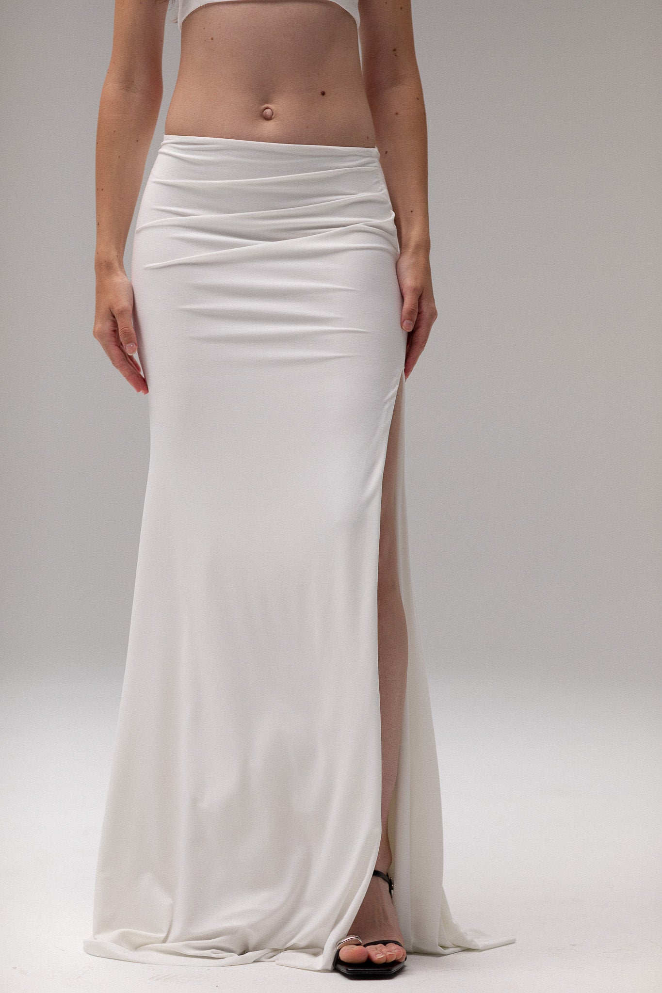 Bride in a draped knit slit skirt from TEMPÊTE, showcasing a fitted silhouette with a stylish slit, ideal for a bold and contemporary bridal outfit