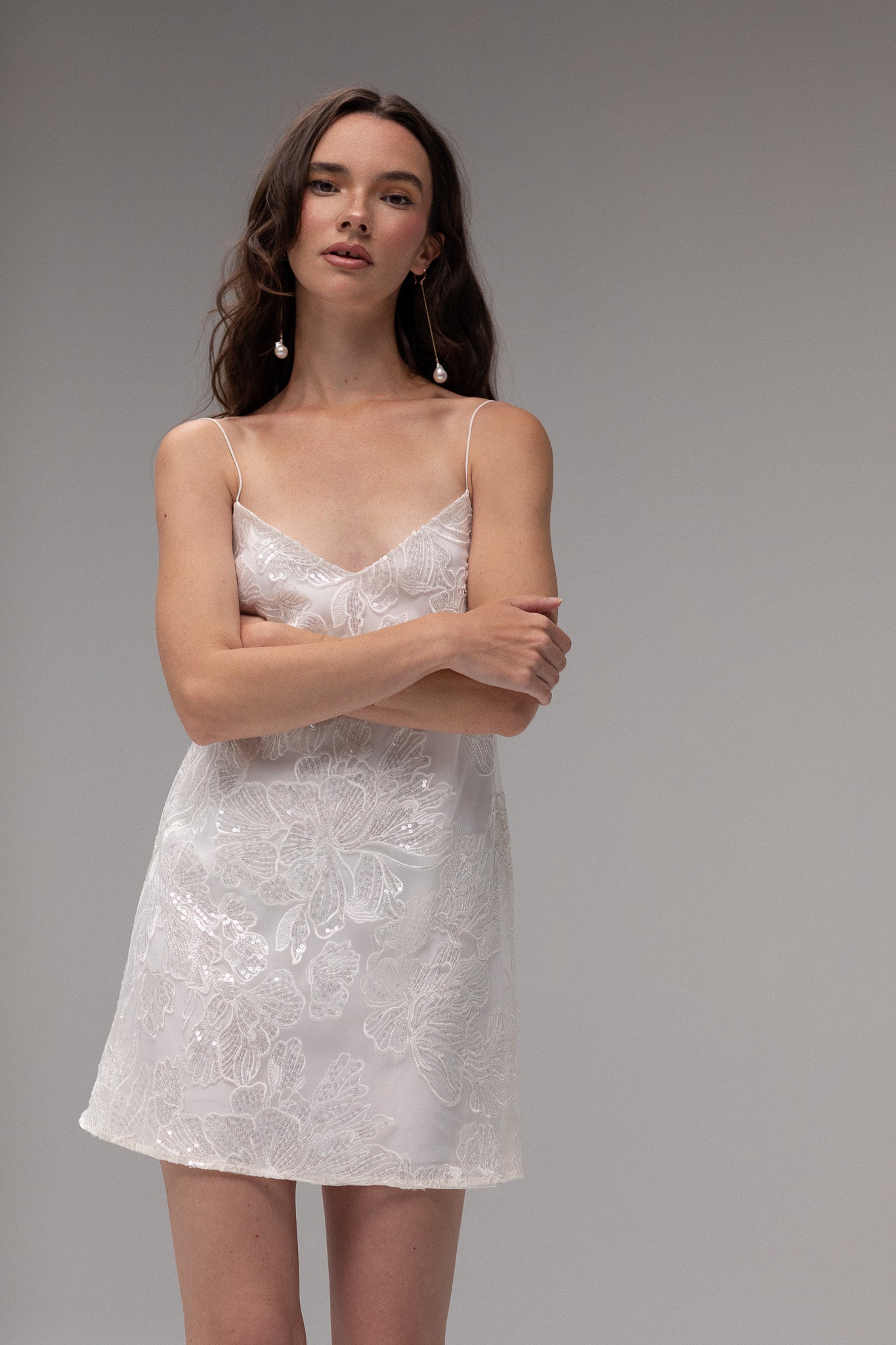 Detailed view of TEMPÊTE mini bridal dress with delicate sequin lace, spaghetti straps, and an open back, ideal for a chic after-party look