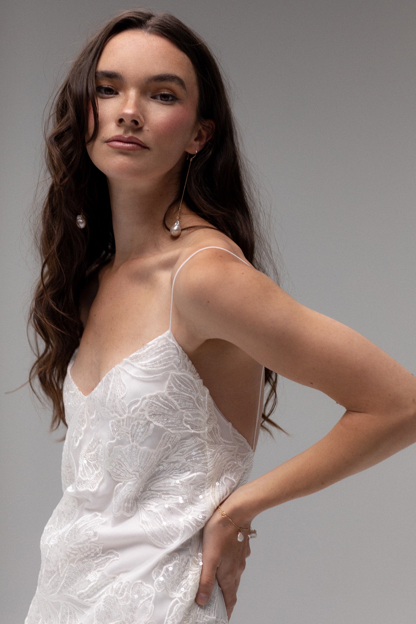 Detailed view of TEMPÊTE mini bridal dress with delicate sequin lace, spaghetti straps, and an open back, ideal for a chic after-party look