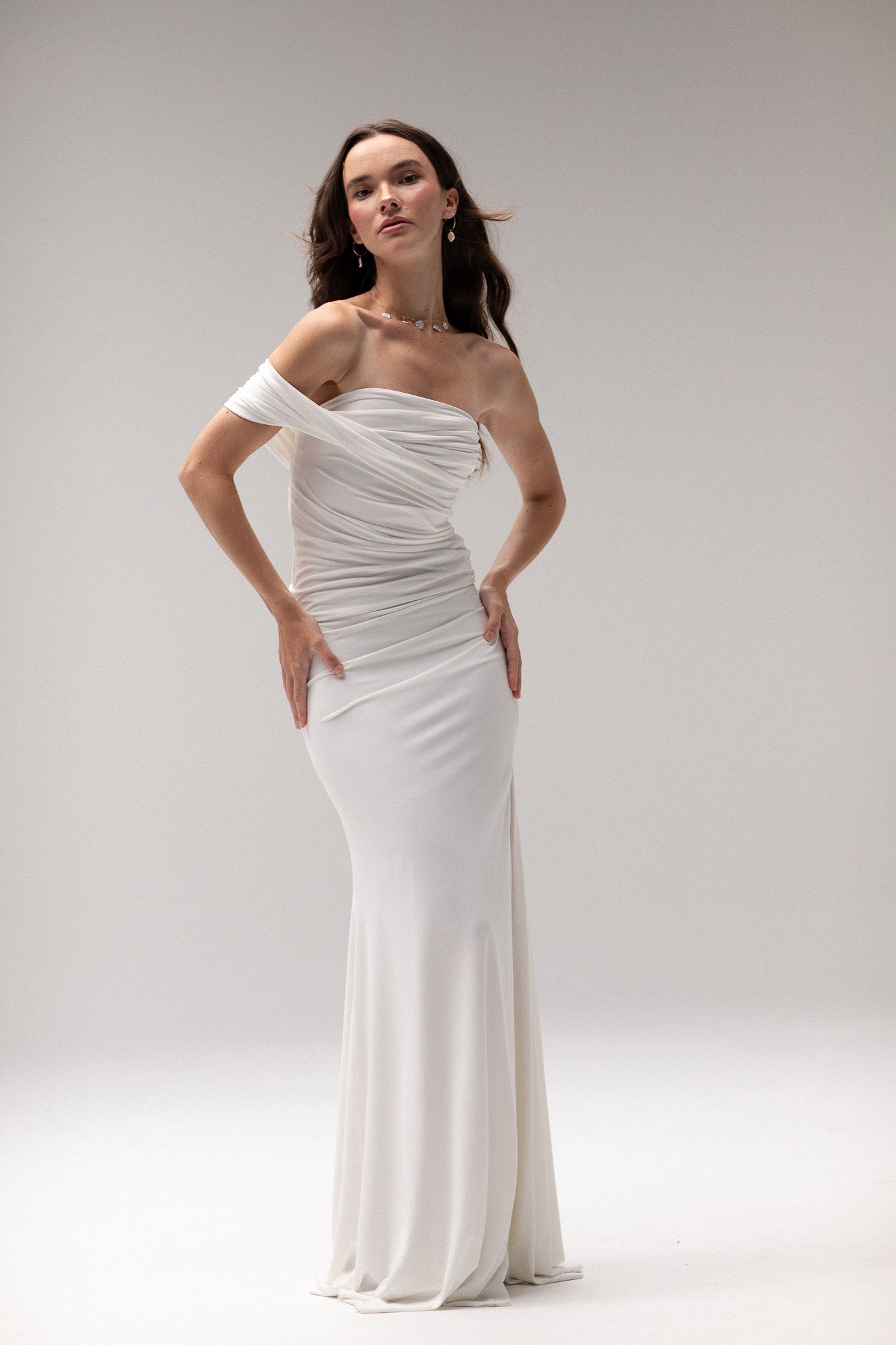 Bride in a draped knit slit skirt from TEMPÊTE, showcasing a fitted silhouette with a stylish slit, ideal for a bold and contemporary bridal outfit