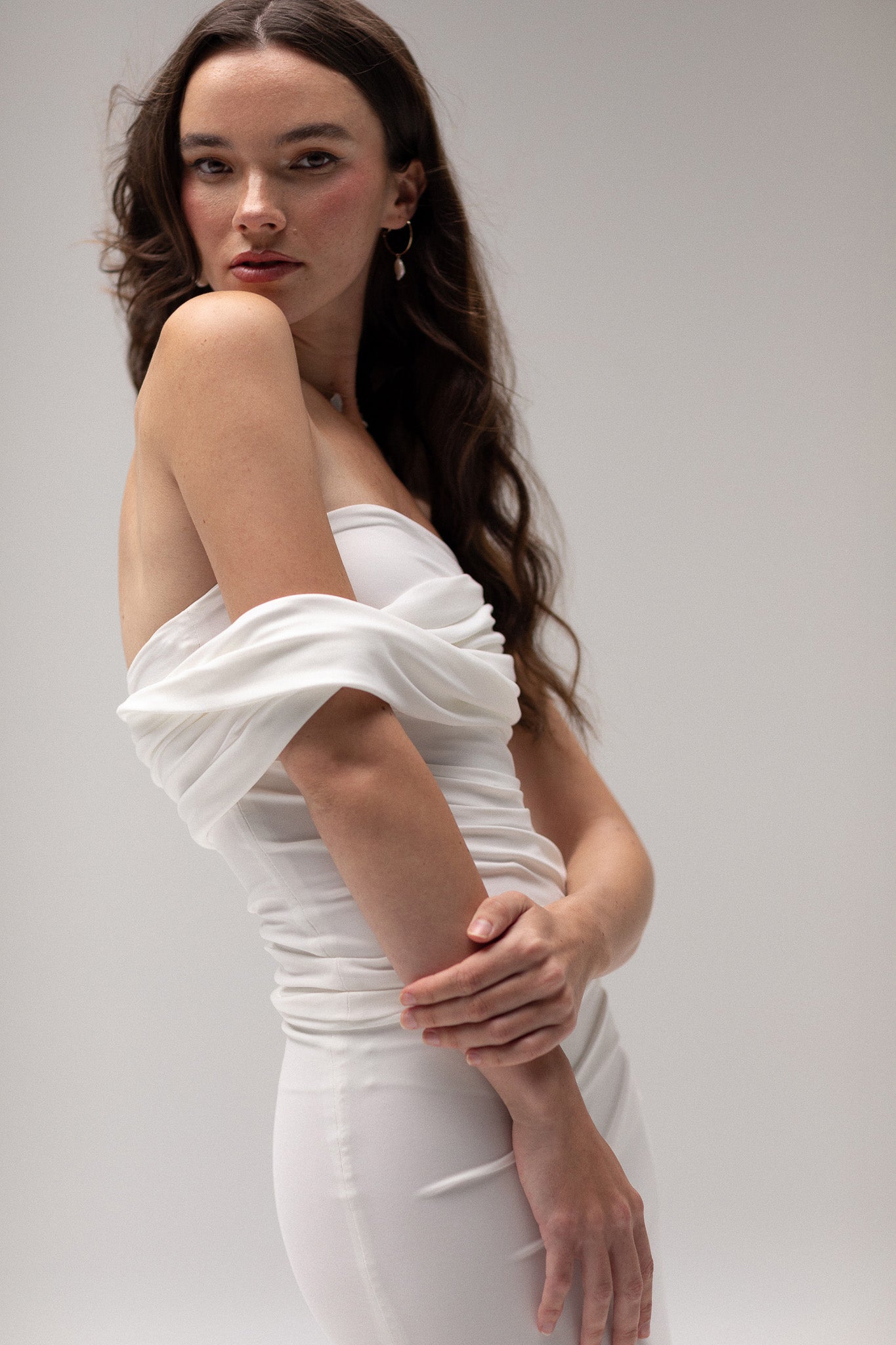 Bride in a draped one-shoulder knit top from TEMPÊTE, showcasing a stylish and elegant design that pairs beautifully with any bridal skirt or pants