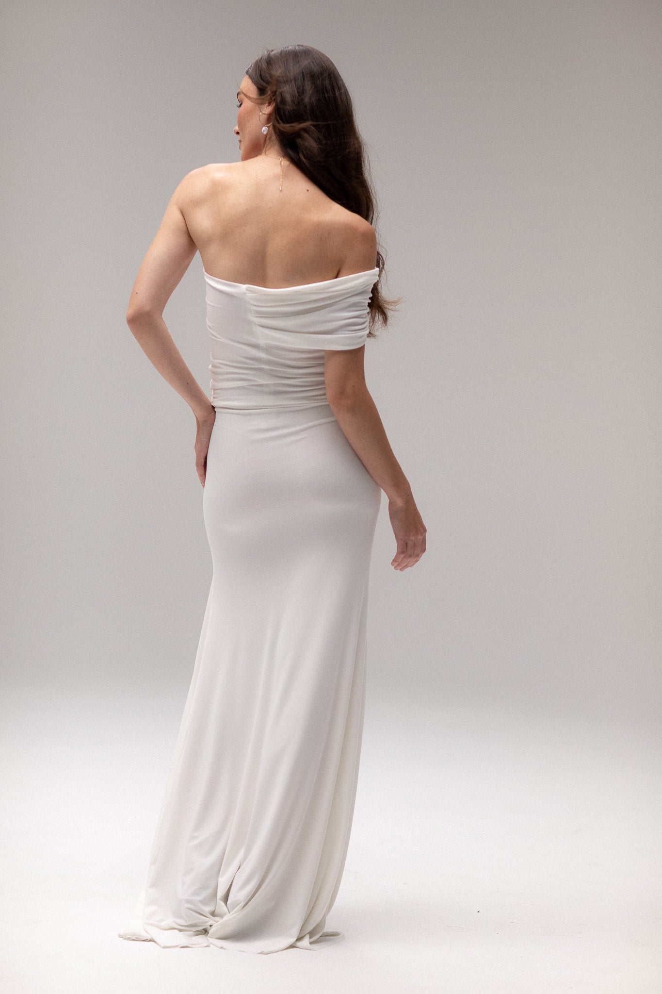 Bride in a draped knit slit skirt from TEMPÊTE, showcasing a fitted silhouette with a stylish slit, ideal for a bold and contemporary bridal outfit