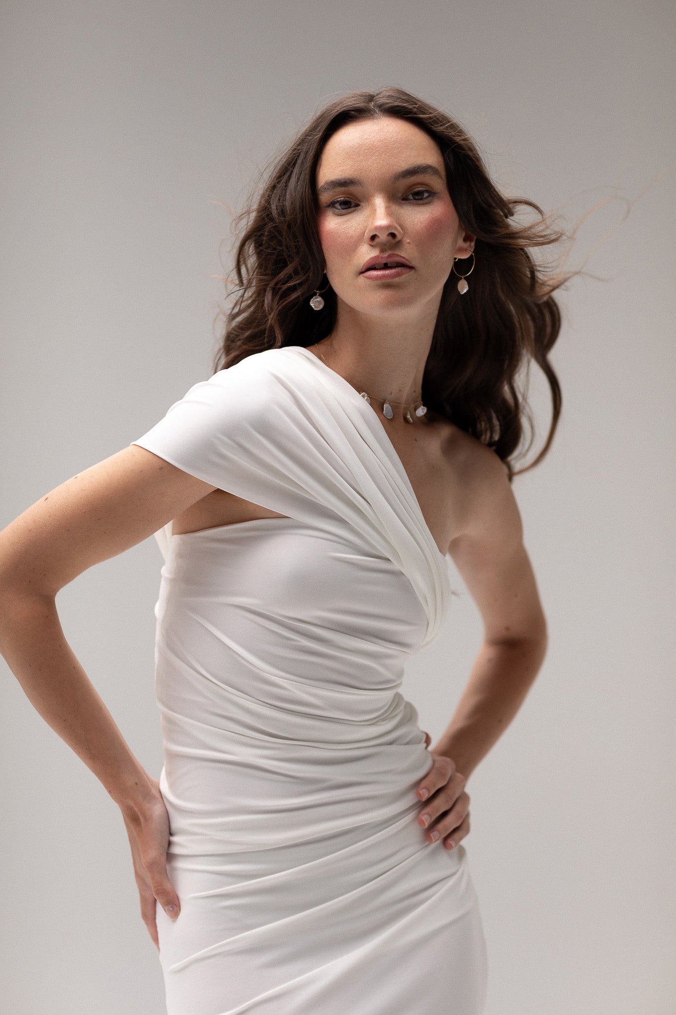 Bride in a draped one-shoulder knit top from TEMPÊTE, showcasing a stylish and elegant design that pairs beautifully with any bridal skirt or pants