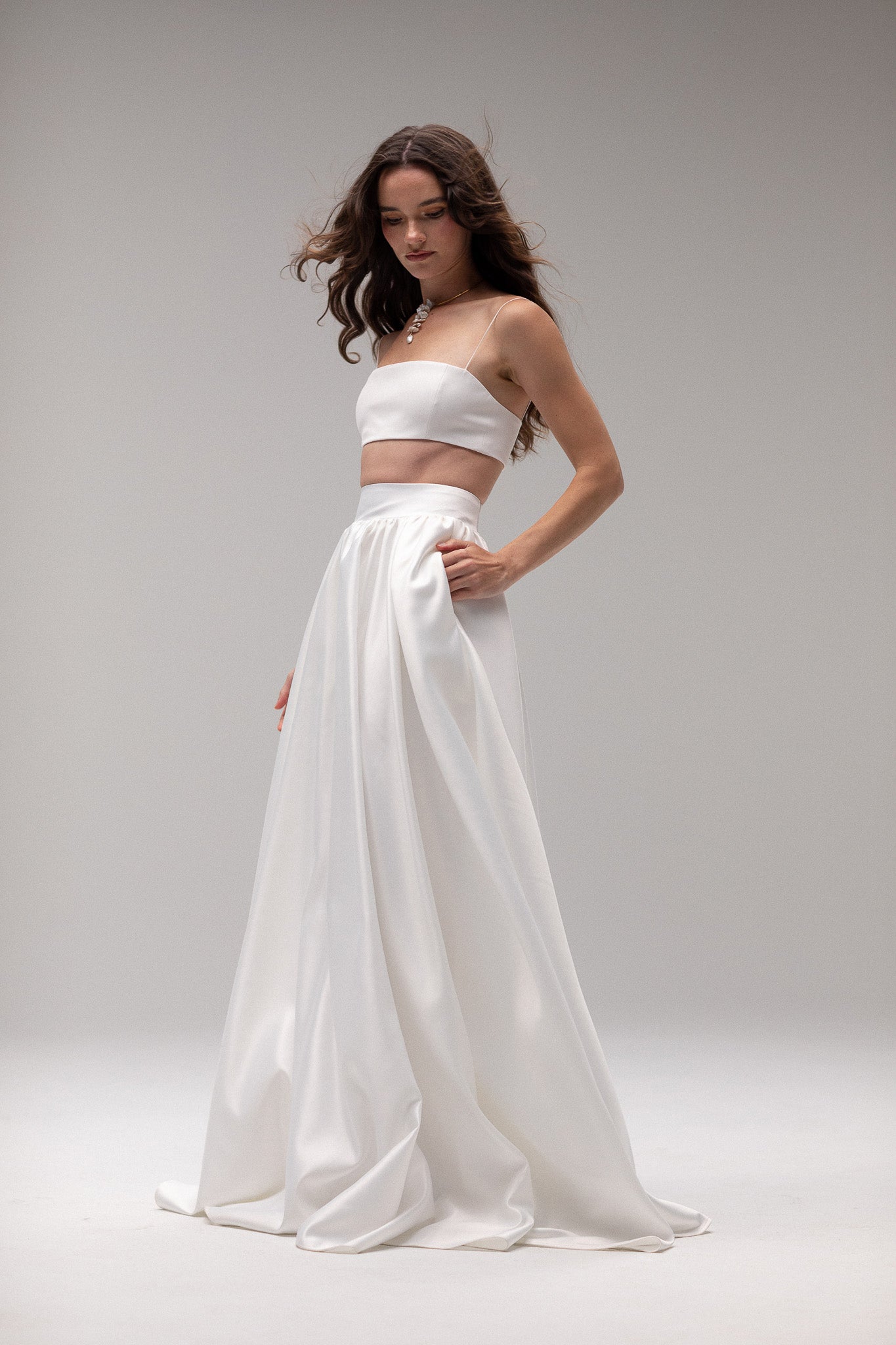 Detailed view of a high-waisted satin gathered maxi skirt by TEMPÊTE, offering an elegant and modern fit.