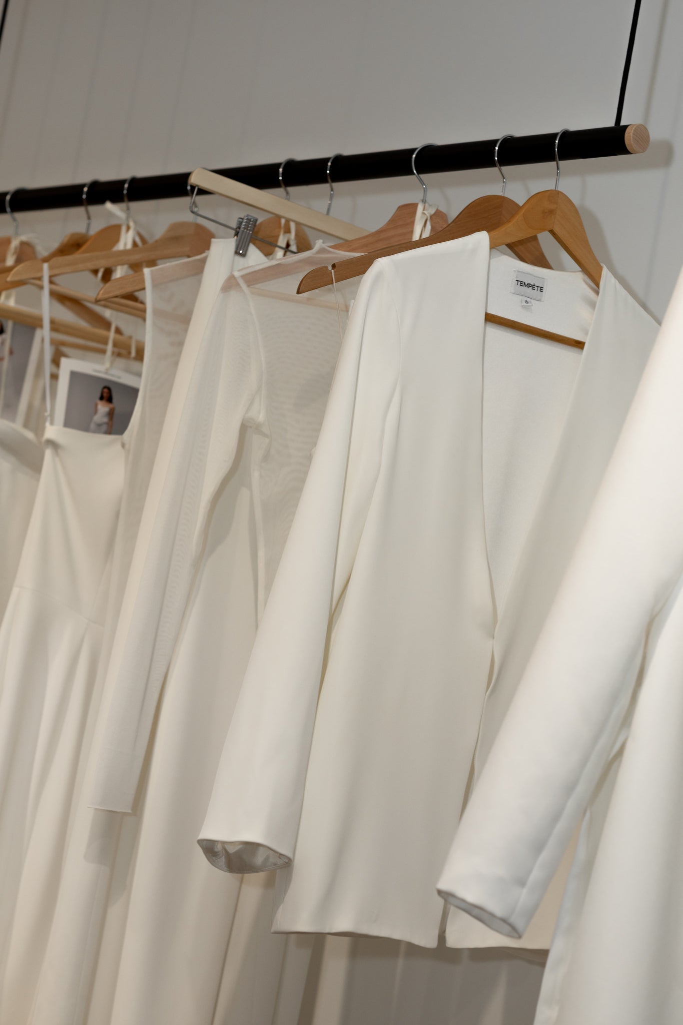 Wedding Dresses and Blazers on Hangers at TEMPÊTE Bridal Boutique in Vancouver