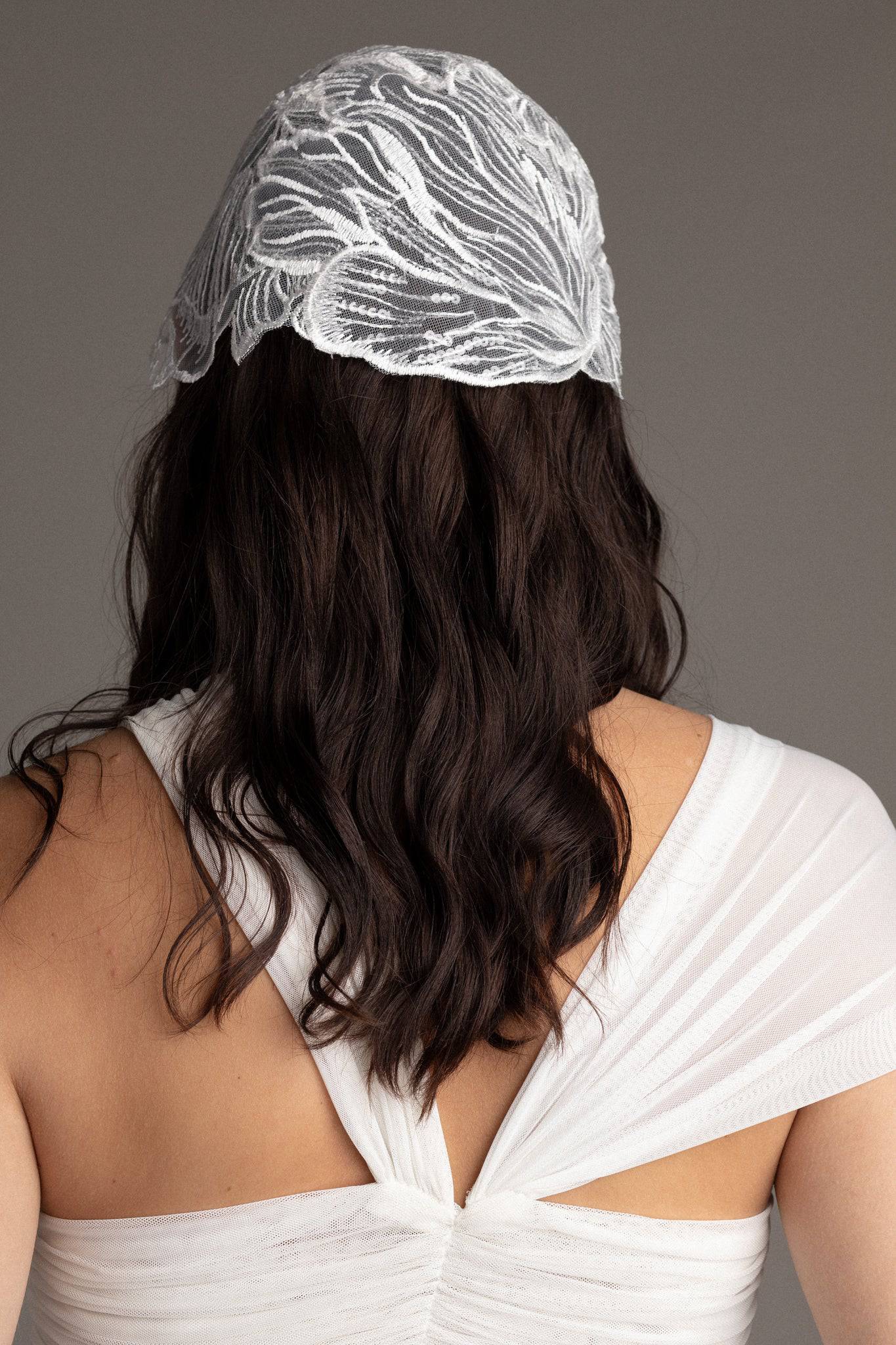 Back of a sequin bridal bonnet by TEMPÊTE, designed with freshwater pearls and crystals.