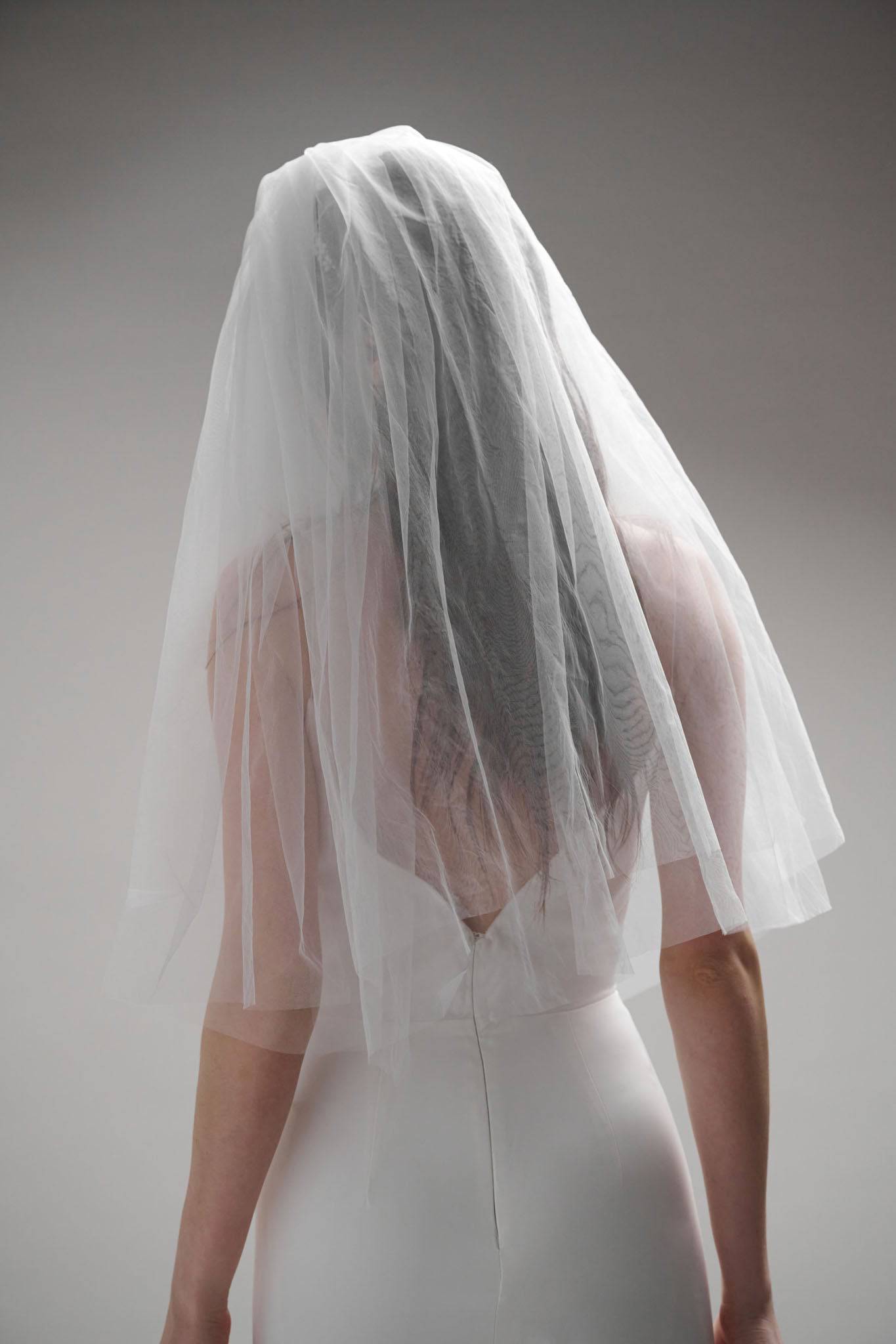 Back of Brume Minimalist Veil by TEMPÊTE, featuring two blunt layers of fine cascading tulle and a sleek gold comb.