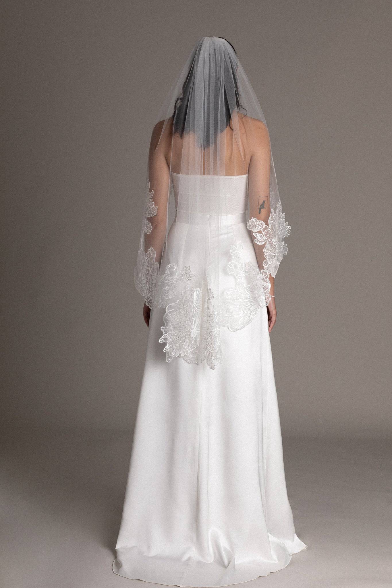 The back of French lace tulle veil by TEMPÊTE bridal brand with delicate floral sequin applique on the edges