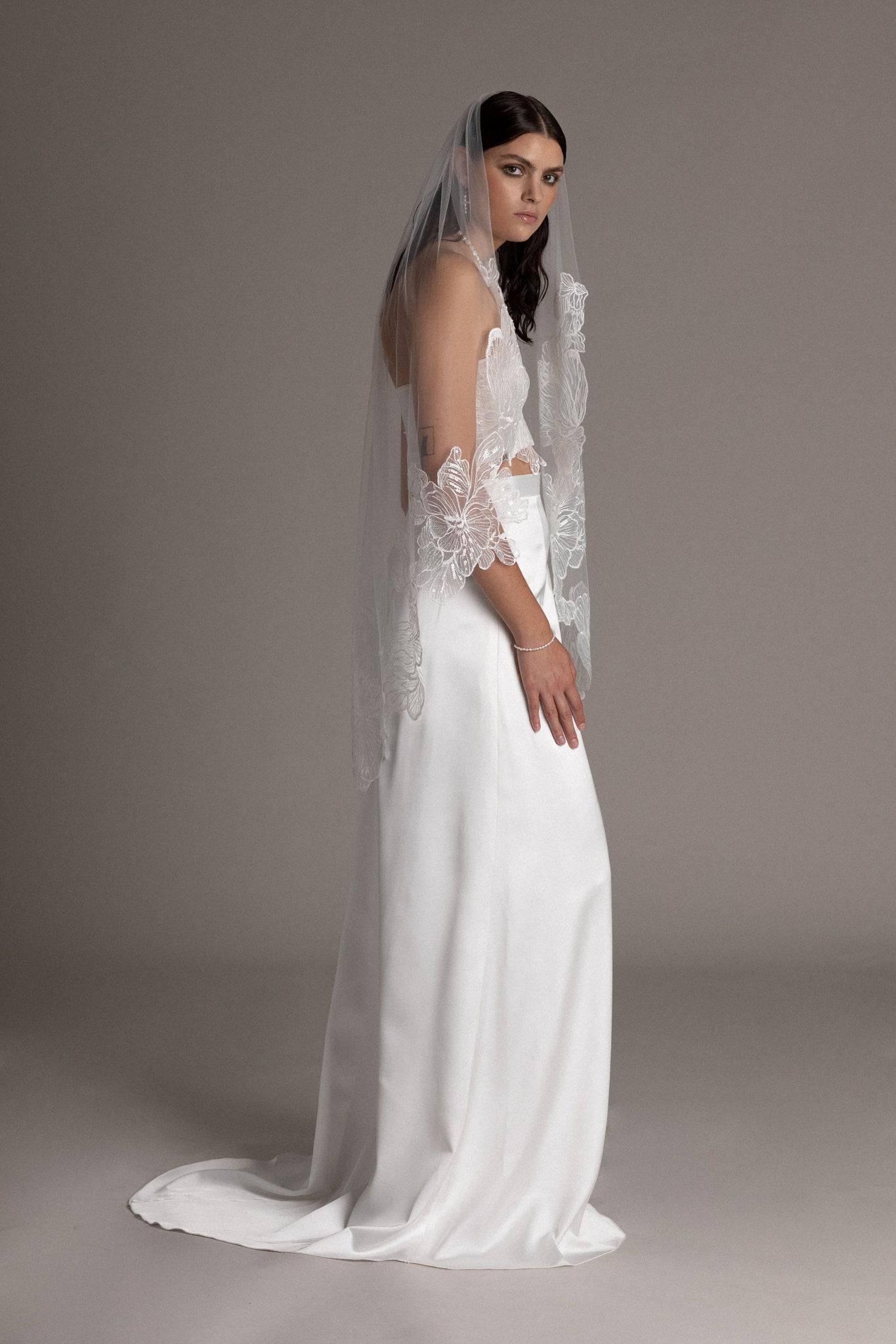 Side view of French lace tulle veil by TEMPÊTE bridal brand with delicate floral sequin applique on the edges