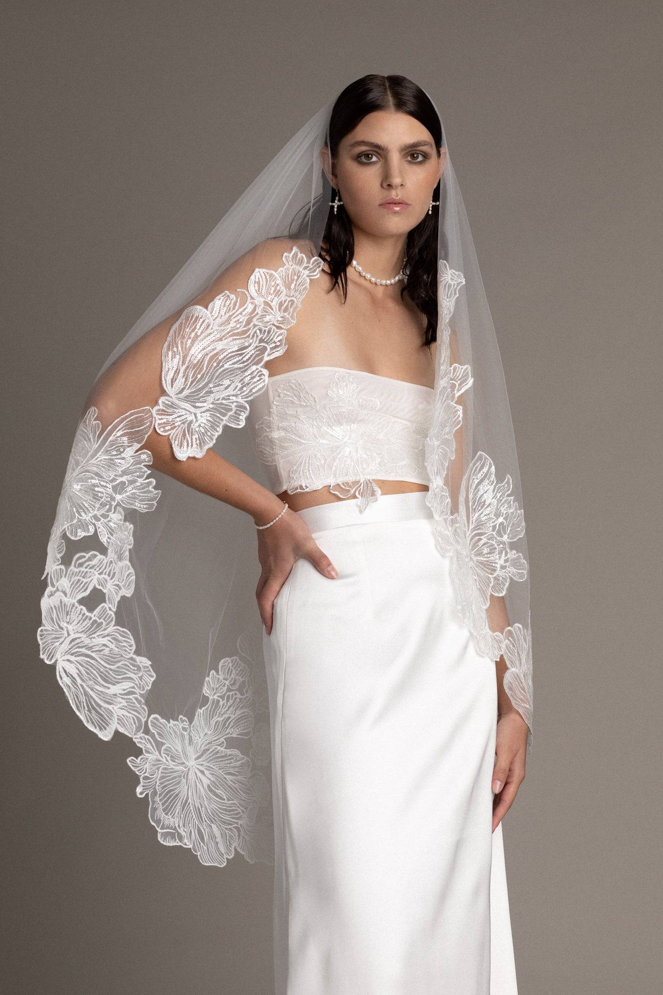 French lace tulle veil by TEMPÊTE bridal brand with delicate floral sequin applique on the edges