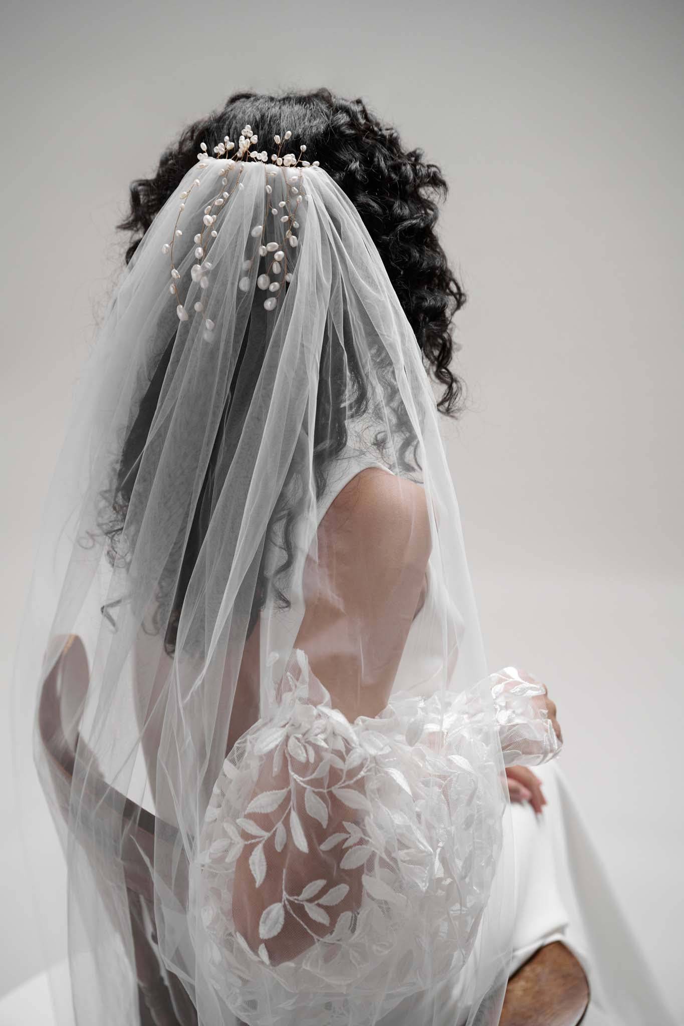 Freshwater pearl tulle veil by TEMPÊTE featuring Cascading strands of freshwater pearls sit among layers of soft ivory tulle.