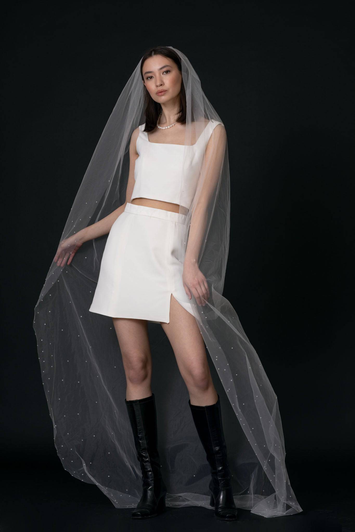 Acacia Pearl Veil by TEMPÊTE, crafted from soft, silky tulle with a delicate pearl trim along the edges, secured with a comb for easy placement.