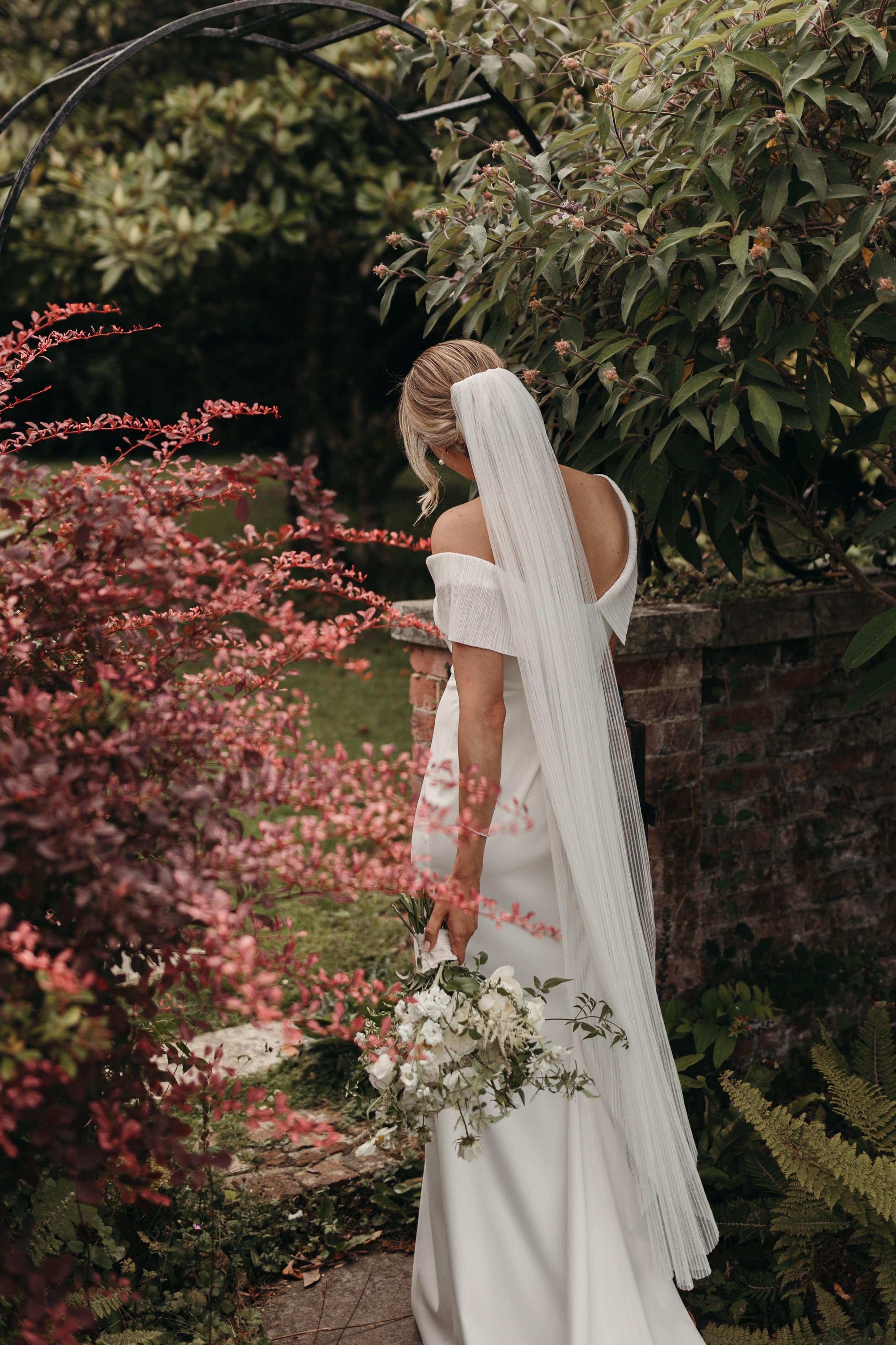 Bride is wearing best-selling Coquille Pleated Tulle Veil by TEMPÊTE, completed with a minimalist gold comb.