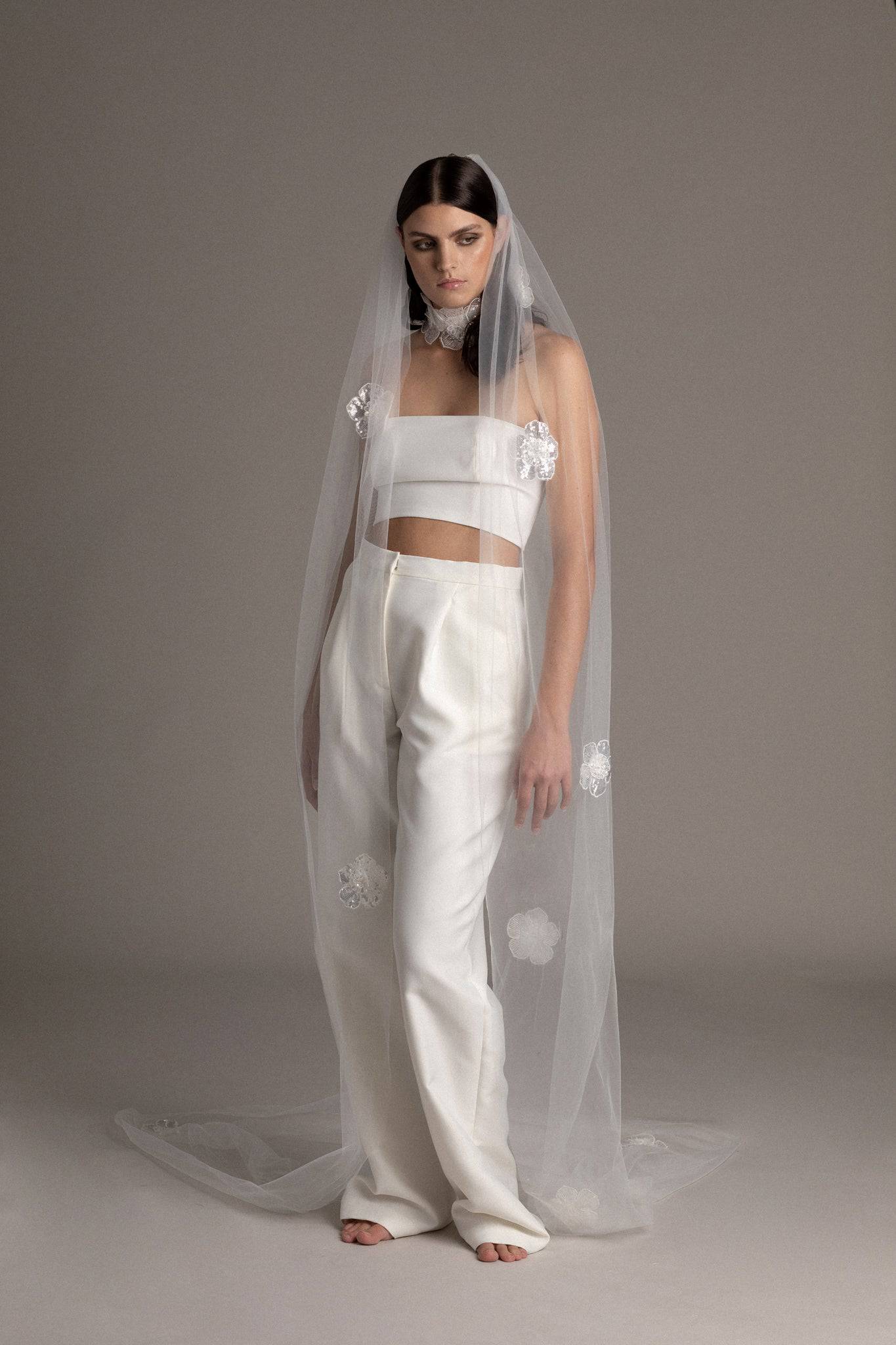 Bride wearing the Sequin Flower Tulle Veil by TEMPÊTE, featuring delicate sequin flowers that span the length of the veil