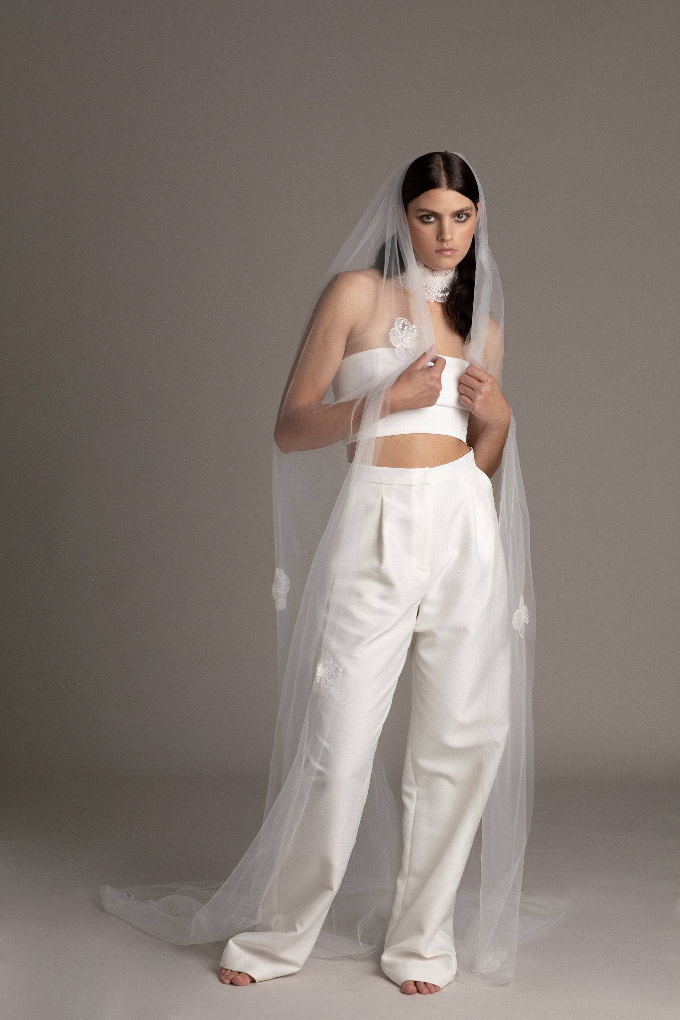 Bride wearing the Sequin Flower Tulle Veil by TEMPÊTE, featuring delicate sequin flowers that span the length of the veil