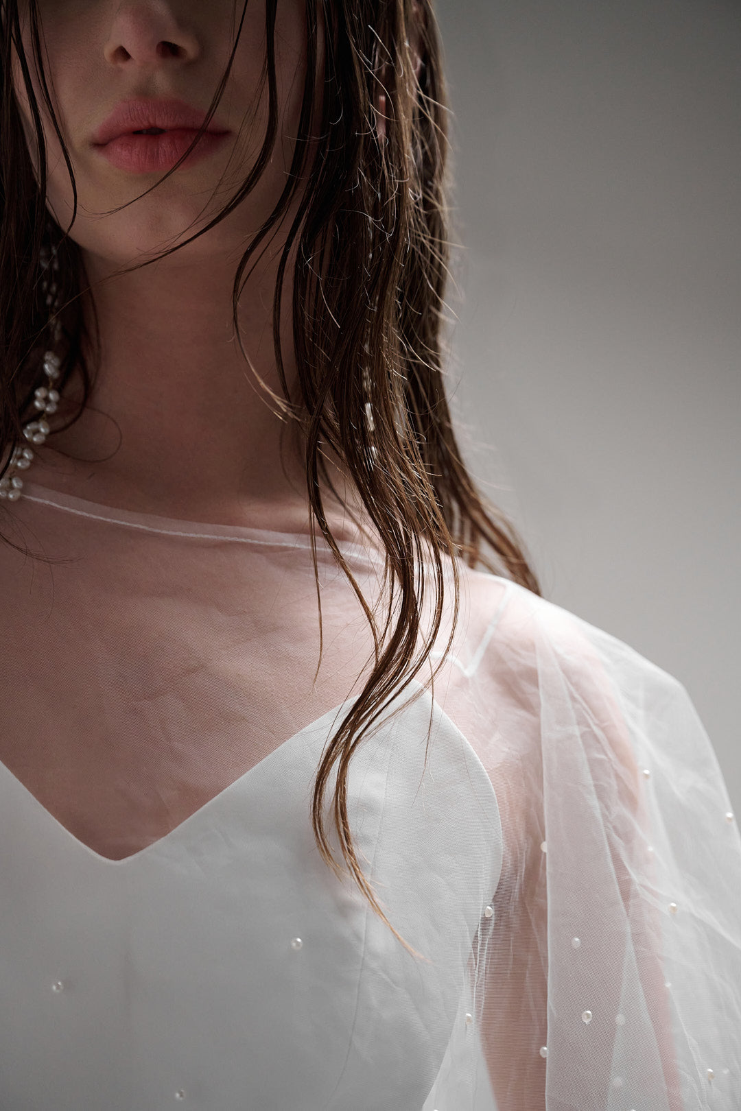 Iris Cape - a sheer and refined pearl cape that brings an elegant flair to any wedding day look, without upstaging the dress. Featuring tiny glistening pearls, this cape is a perfect accessory for a minimal but impactful statement