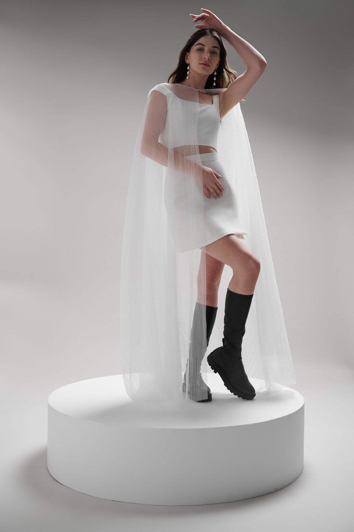 Coquille Cape - a modern veil alternative made with translucent tulle that adds ethereal beauty to any look. Featuring a hidden hook and eye closure for easy removal and showcasing the details underneath, this accessory is an effortless two-in-one outfit