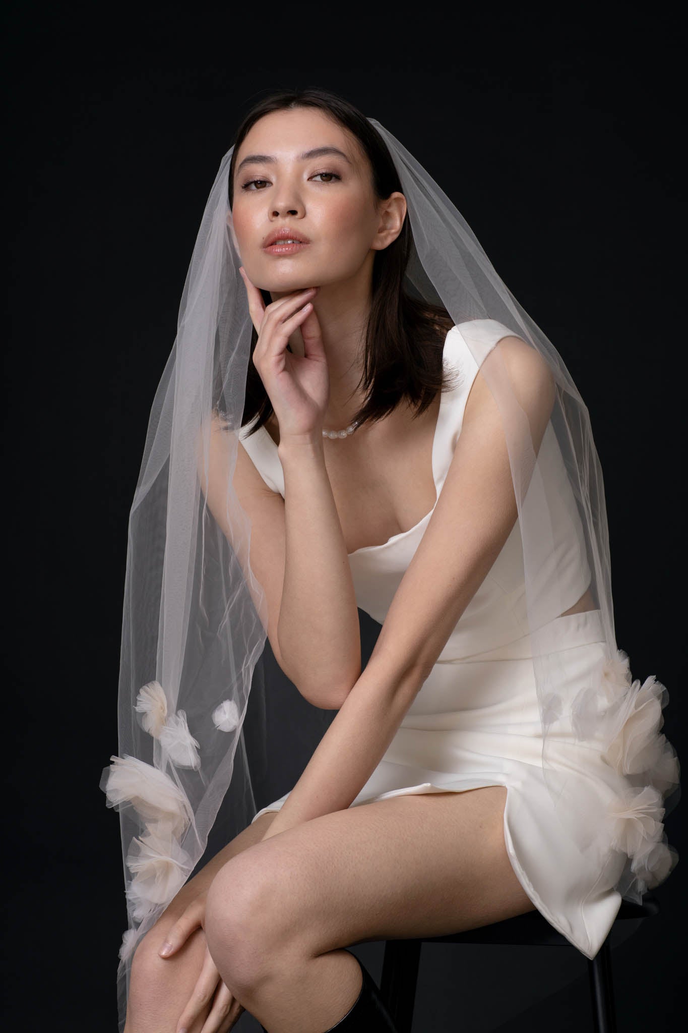 The Jardin Wedding Veil by TEMPÊTE, featuring delicate handcrafted tulle flowers in contrasting white and light beige colours.